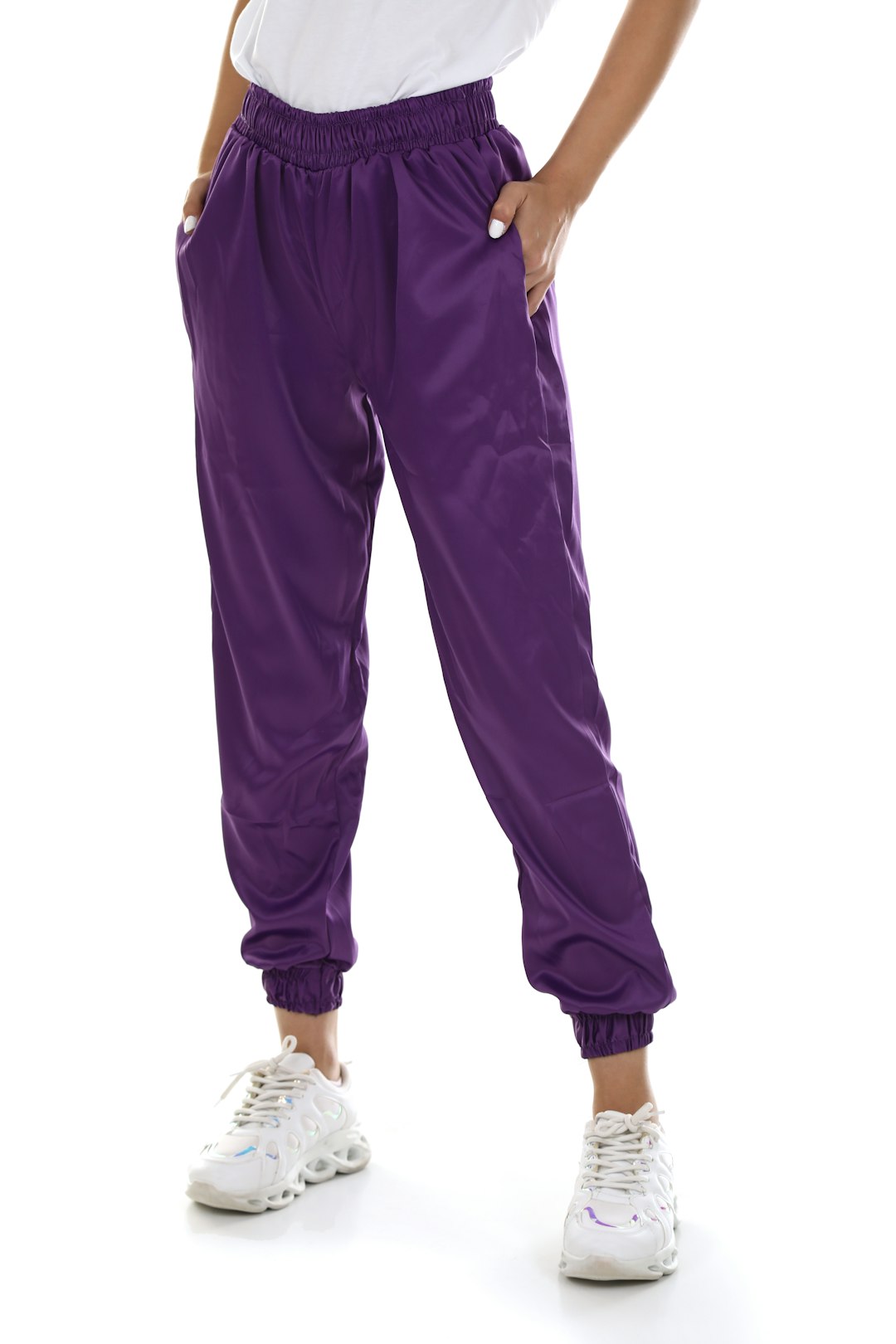 a woman in a white shirt and purple pants